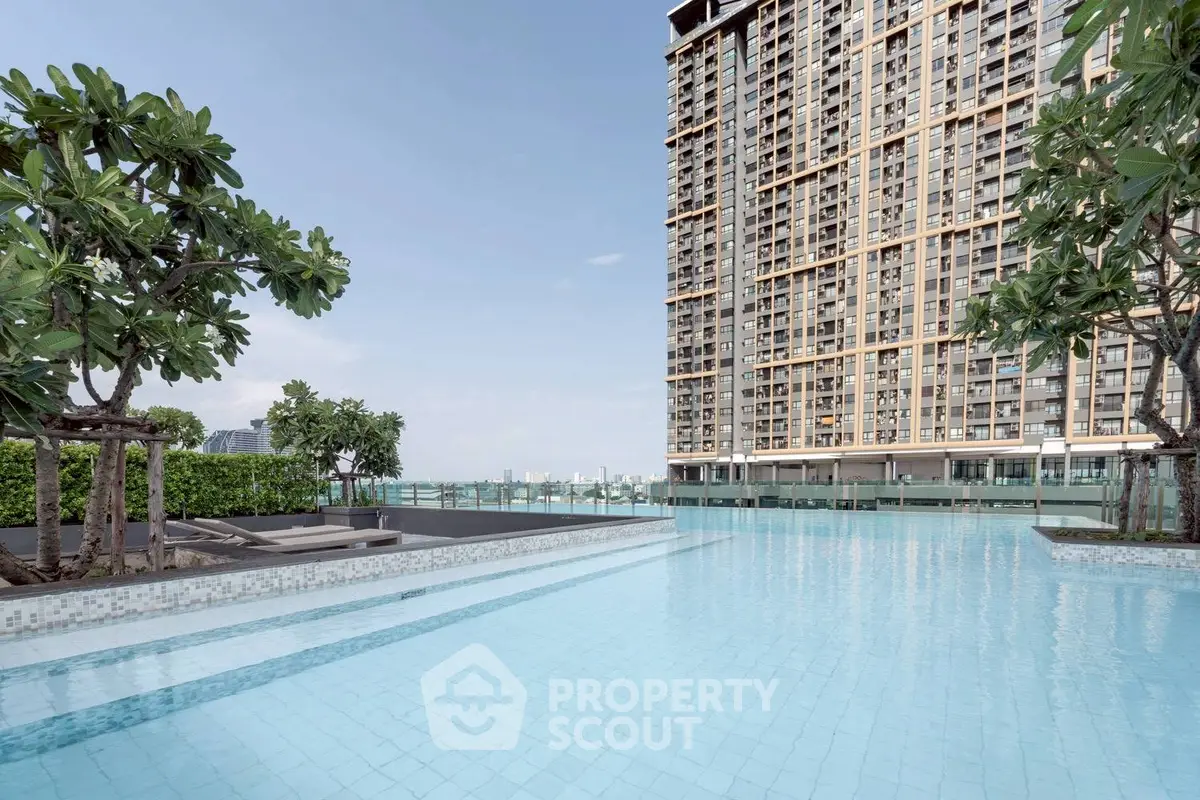 Luxurious high-rise building with stunning pool and city views, perfect for modern urban living.
