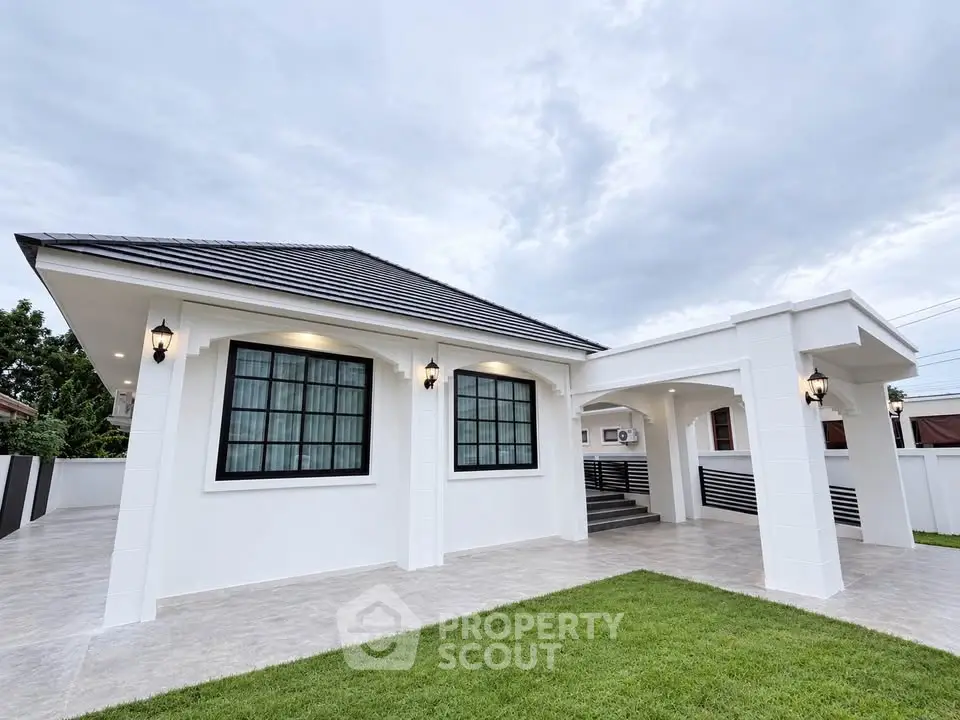Modern single-story house with sleek design and spacious driveway, perfect for family living.