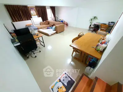 Spacious living room with modern furniture and home office setup