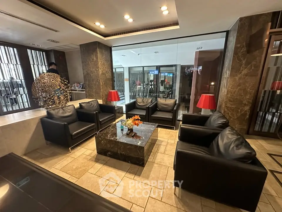 Luxurious lobby with elegant seating and modern decor in a high-end building.