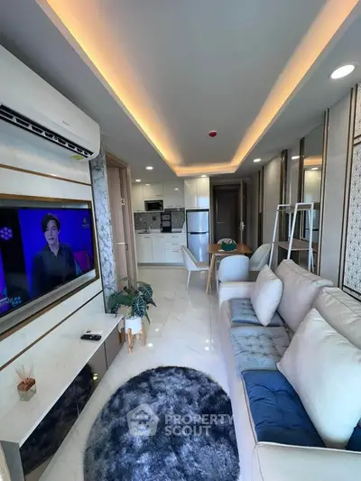 Modern living room with sleek design, cozy seating, and open kitchen layout.