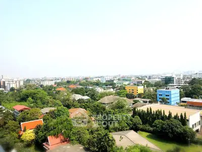 Stunning aerial view of lush green neighborhood with vibrant buildings and clear skies.
