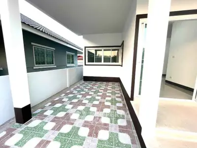 Spacious tiled balcony with modern design and ample natural light.