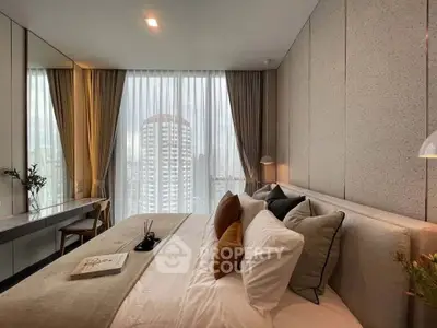 Luxurious bedroom with city view, elegant decor, and ample natural light.