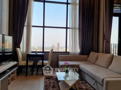 Spacious living room with stunning city view, modern furniture, and elegant decor.