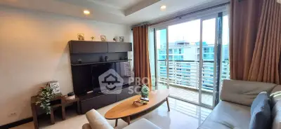 Modern living room with balcony view, stylish furniture, and natural light.