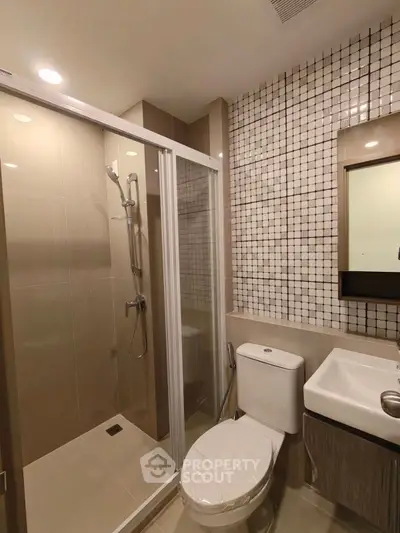 Modern bathroom with glass shower and stylish tile design