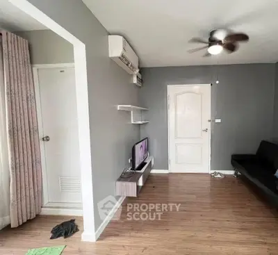 Modern living room with sleek design, featuring wooden flooring and minimalist decor.