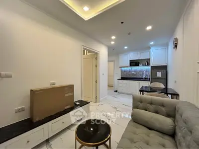Modern living room with elegant kitchen, marble flooring, and cozy sofa in a stylish apartment.