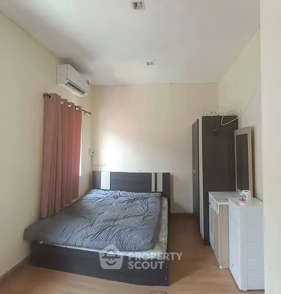 Cozy bedroom with modern furniture and air conditioning, perfect for a comfortable living experience.