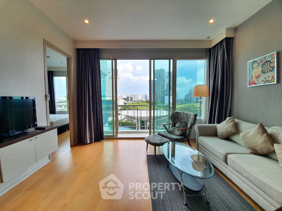 Modern living room with large windows offering city view, stylish furniture, and wooden flooring.