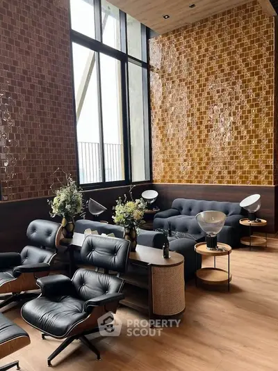 Luxurious modern living room with high ceilings and elegant leather furniture.