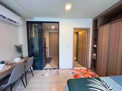 Modern studio apartment with open layout, featuring a cozy dining area and stylish bedroom.