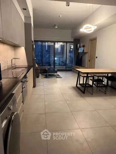 Modern open-plan living room with sleek kitchen and stylish dining area