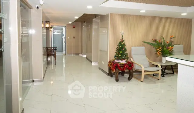 Elegant lobby with marble flooring and festive decor in modern building