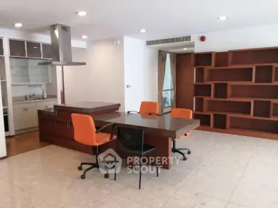 Spacious open-plan kitchen and dining area with modern cabinetry and ample natural light.