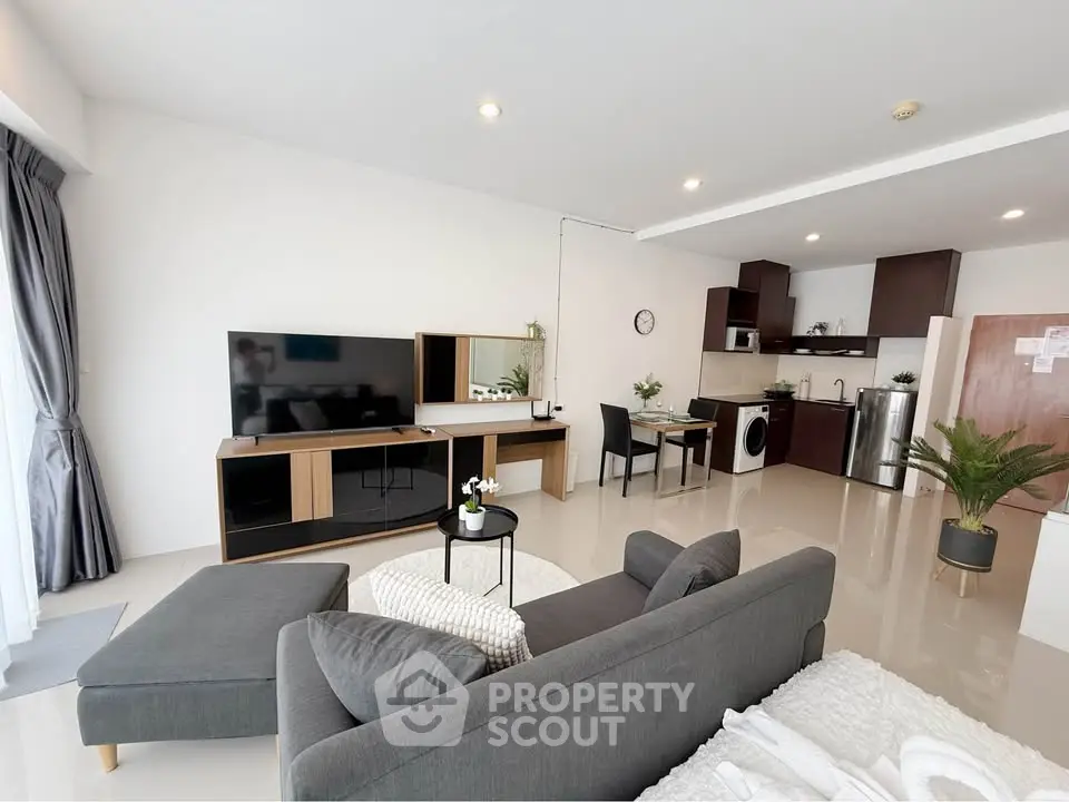 Spacious modern living room with open kitchen and sleek furniture