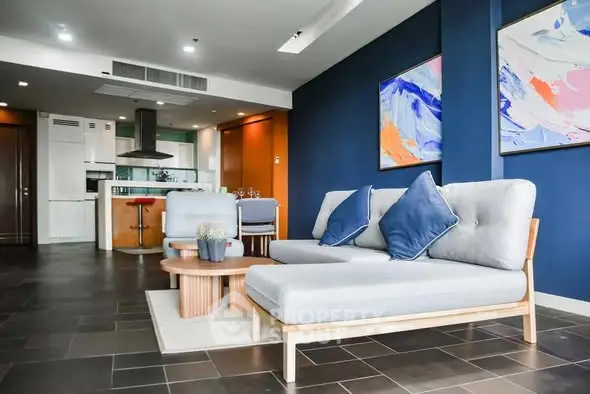 Modern living room with stylish furniture and open kitchen layout