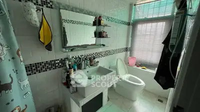 Charming bathroom with modern fixtures and natural light, perfect for relaxation.