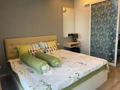 Modern bedroom with stylish decor and floral accents, featuring a comfortable bed and elegant furnishings.