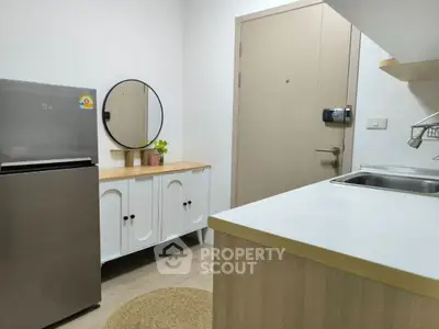 Modern kitchen with sleek fridge and stylish cabinetry
