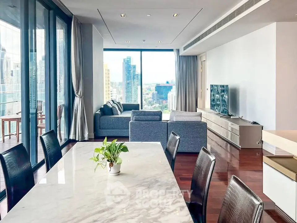 Luxurious open-plan living room with stunning city view and elegant dining area.