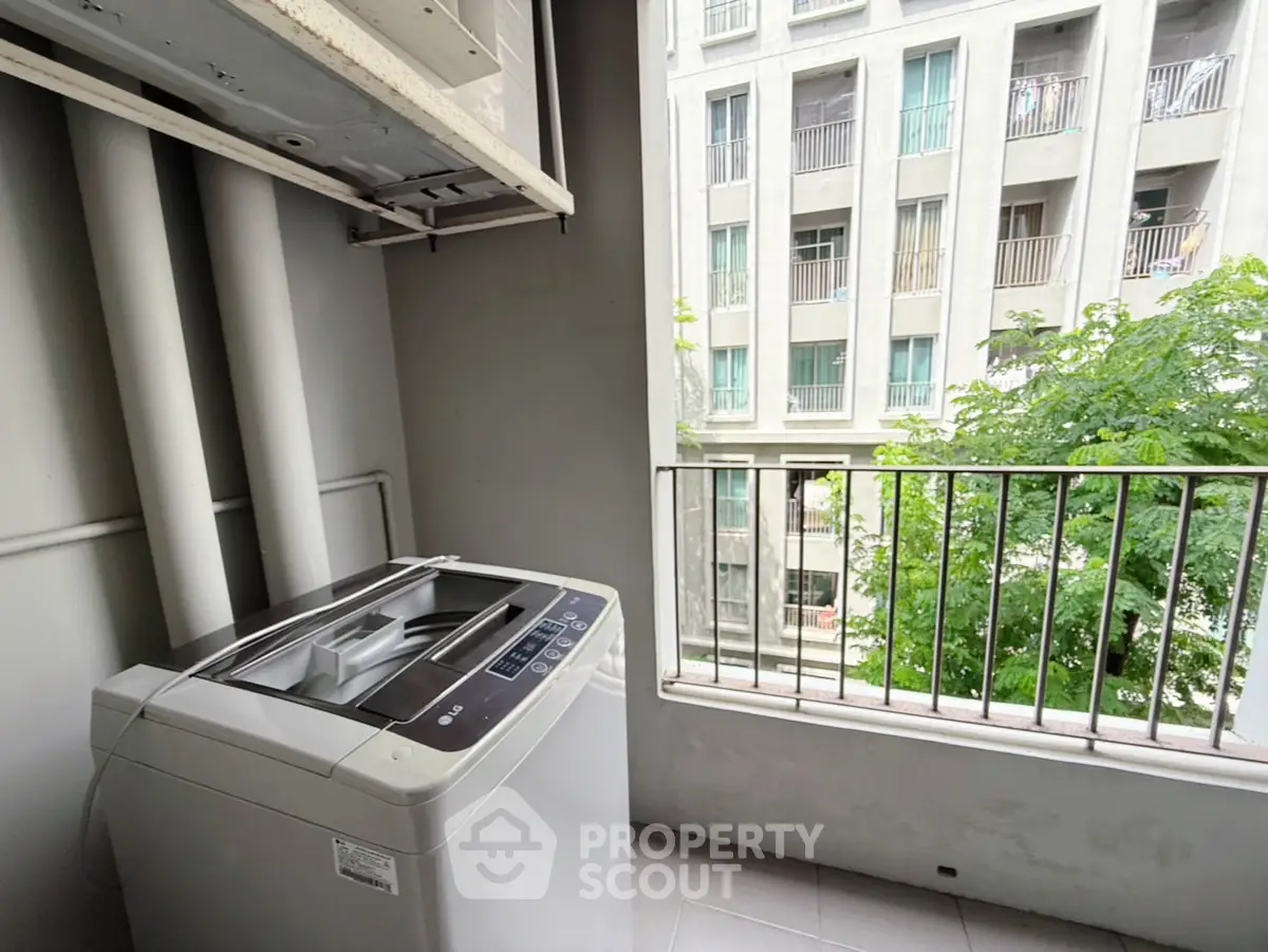 Modern apartment balcony with washing machine and city view