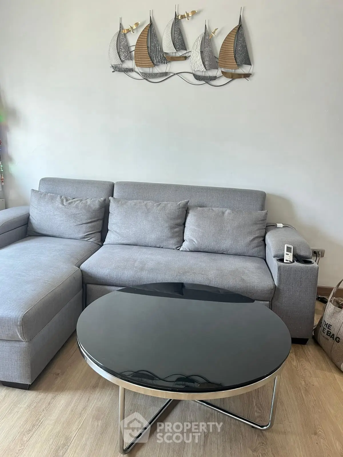 Modern living room with sleek gray sofa and stylish black coffee table, perfect for contemporary home decor.