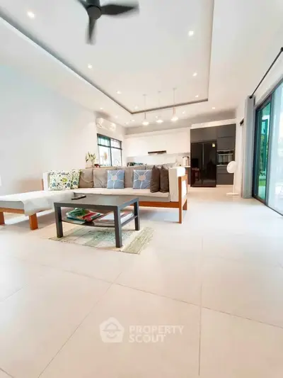 Spacious modern living room with open kitchen and stylish decor