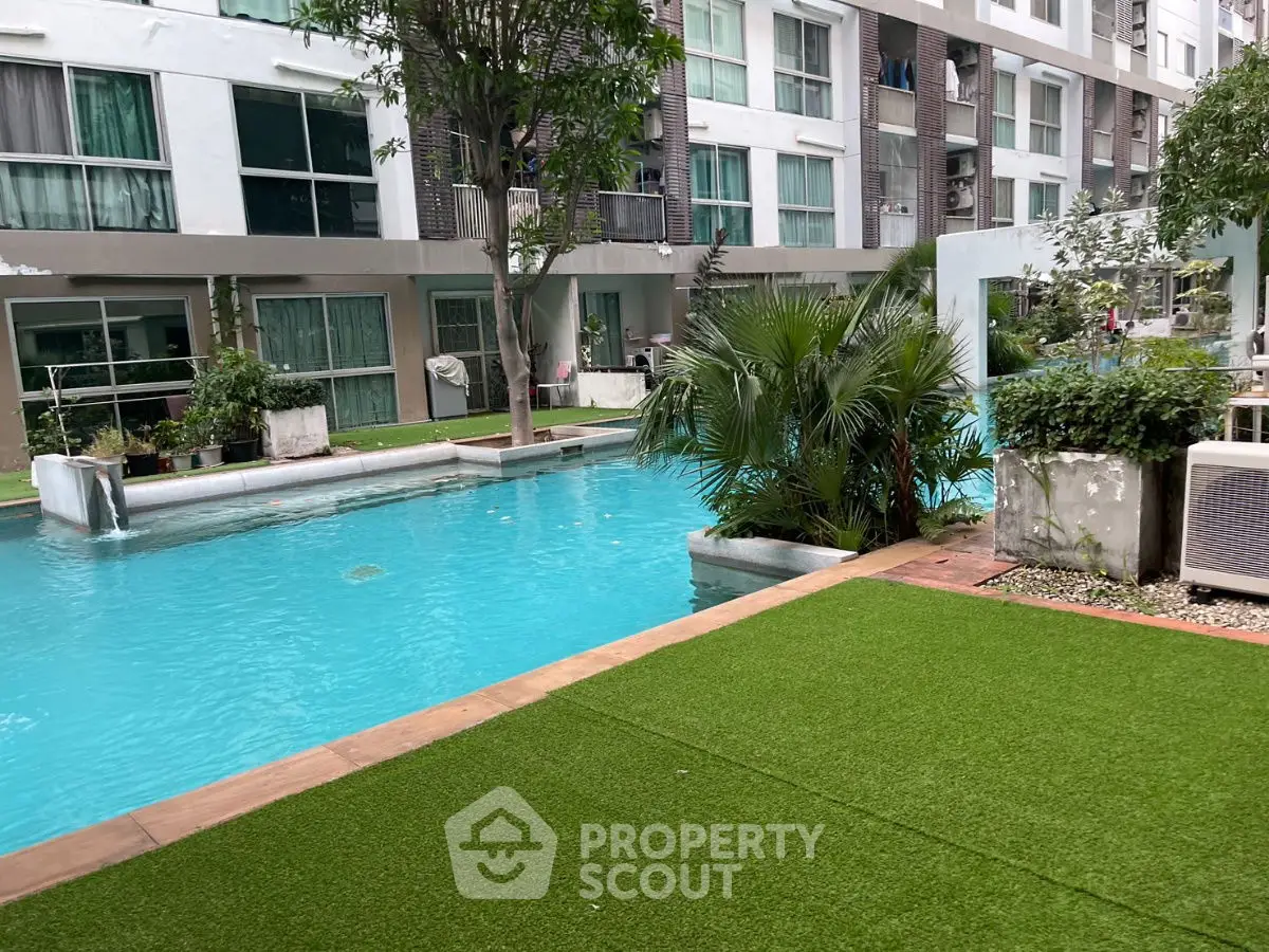 Modern apartment complex with inviting swimming pool and lush greenery