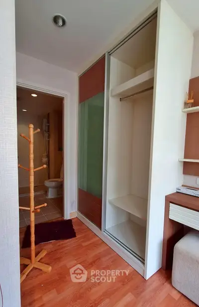 Modern bedroom with sliding closet and wooden flooring