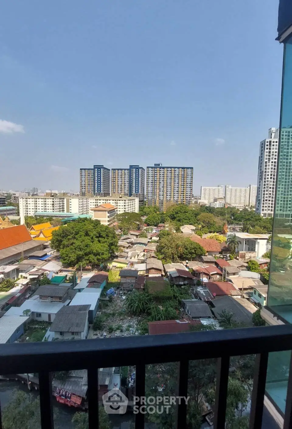 Stunning cityscape view from a high-rise balcony overlooking urban landscape and skyline.