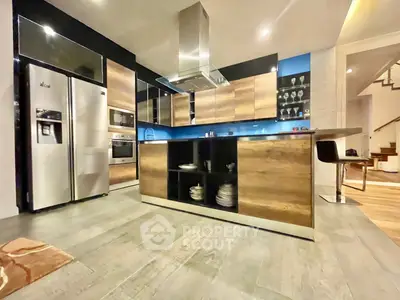 Modern kitchen with sleek appliances and stylish wooden cabinetry