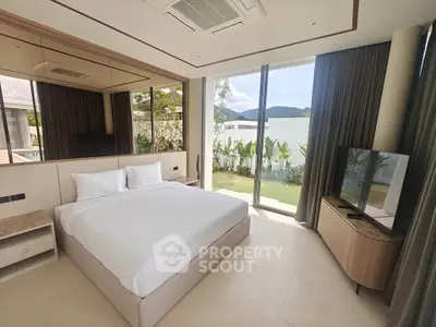 Luxurious bedroom with large windows and garden view in modern home