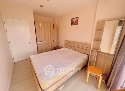 Cozy bedroom with wooden furniture and natural light, perfect for relaxation.
