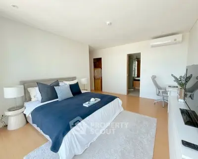 Spacious modern bedroom with elegant decor and natural light