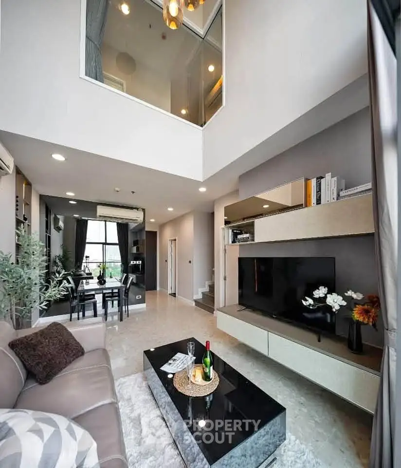 Luxurious modern living room with high ceiling and elegant decor
