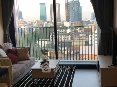 Modern living room with city view from balcony, cozy sofa and stylish decor.