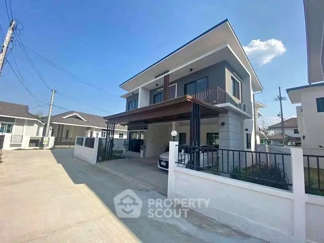 Modern two-story house with spacious driveway and sleek exterior design in a suburban neighborhood.