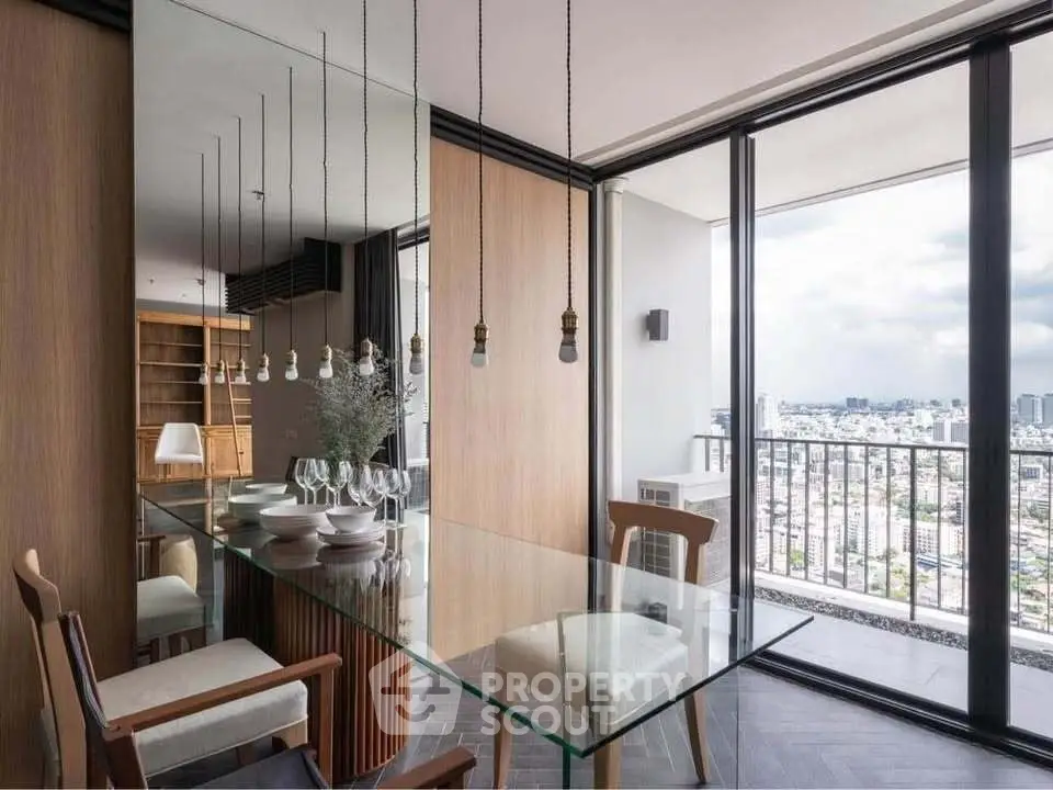 Modern dining area with glass table and city view balcony in luxury apartment