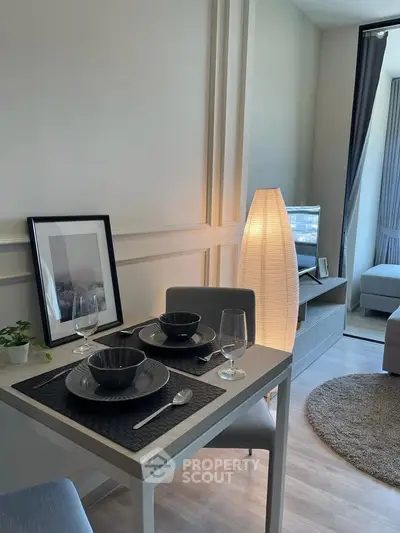 Modern dining area with elegant table setting and cozy living room ambiance.