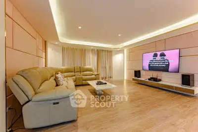 Spacious modern living room with stylish lighting and large sectional sofa.