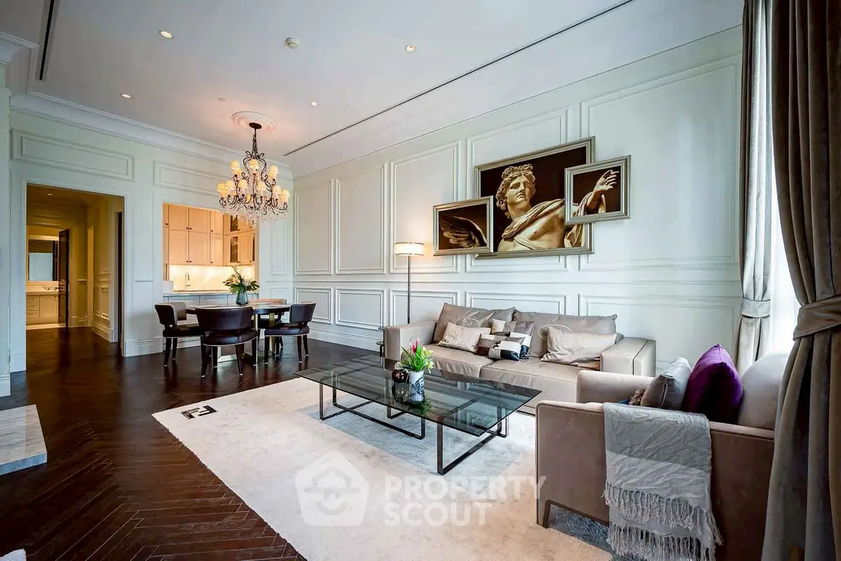 Luxurious living room with elegant decor, chandelier, and modern furniture in a high-end apartment.