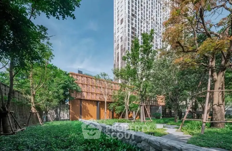 Stunning modern building with lush green garden and elegant architectural design.