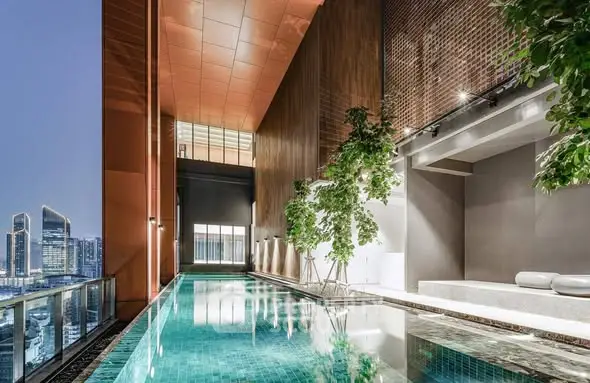 Luxurious rooftop pool with stunning city skyline view and modern design elements.