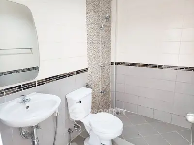 Modern bathroom with sleek fixtures and stylish tile design.