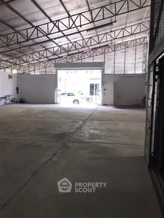 Spacious industrial warehouse with high ceilings and ample natural light.