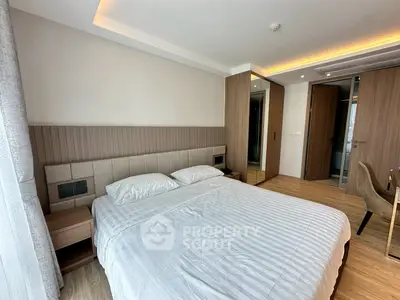 Modern bedroom with stylish decor and ample natural light
