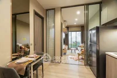 Modern open-plan living room with kitchen and city view balcony in luxury apartment.