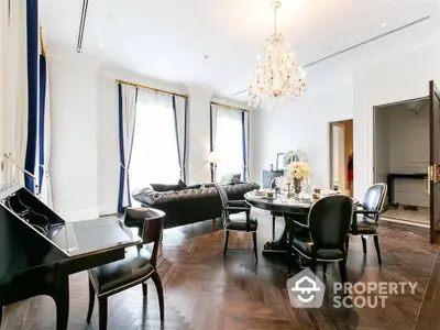 Luxurious living room with polished hardwood floors, elegant chandelier, grand piano, and sophisticated dining area, perfect for upscale urban living.